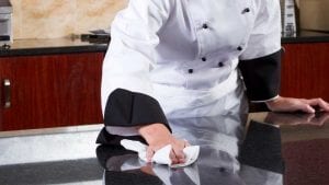 chef wiping kitchen counter