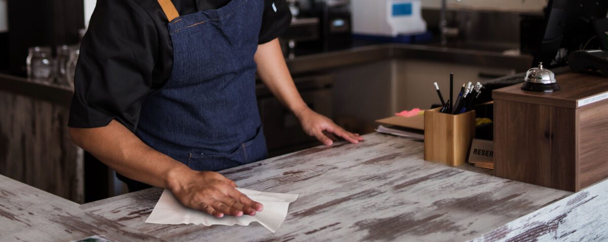 Worker wiping counter with SaniProfessional Cleaning Wipes