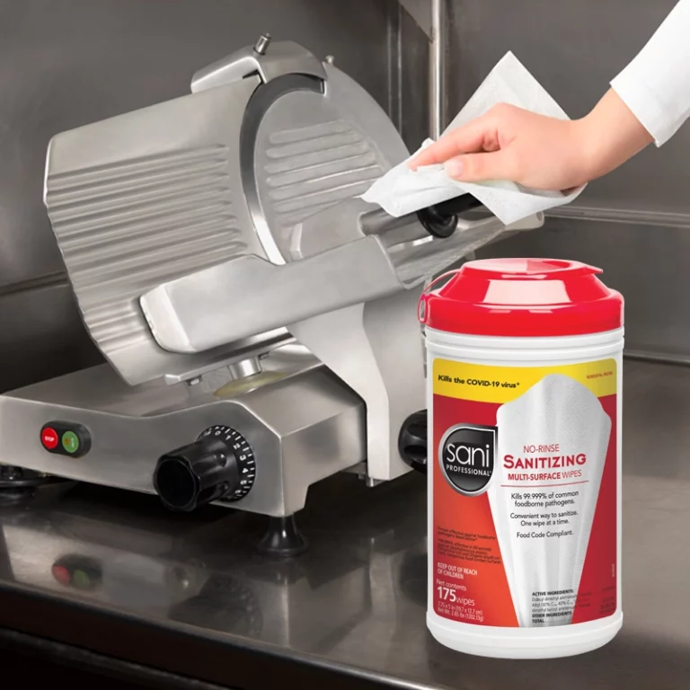 Wiping down a deli Slicer with Sani Professional Wipes to prevent Listeria
