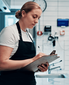Foodservice worker with checlklist - Implementing Active Managerial Control Principles in a Retail Food Business (embed)